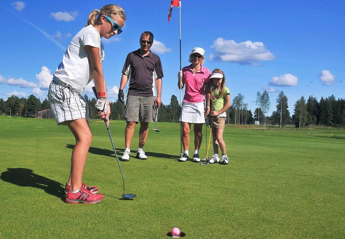 Family-friendly golf courses with family and kid putting